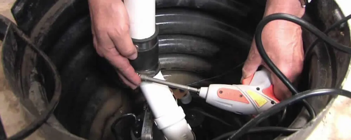 Sump pump installation technician connecting PVC discharge piping in Flagstaff, AZ